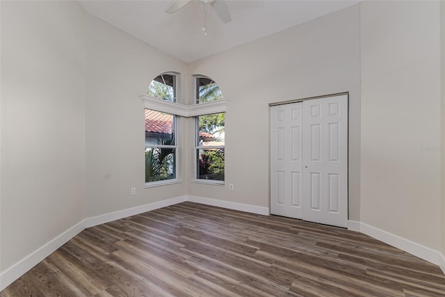 956 Harbor Town Dr, Venice, FL 34292 - unfurnished bedroom featuring high vaulted ceiling, dark wood-type flooring, baseboards, and ceiling fan