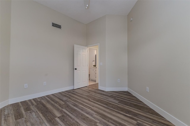 956 Harbor Town Dr, Venice, FL 34292 - empty room with dark wood-type flooring, baseboards, and a towering ceiling