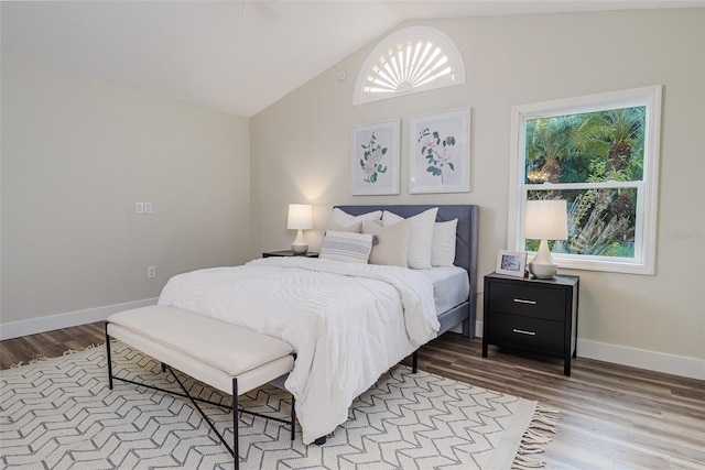 956 Harbor Town Dr, Venice, FL 34292 - bedroom with wood finished floors, vaulted ceiling, and baseboards