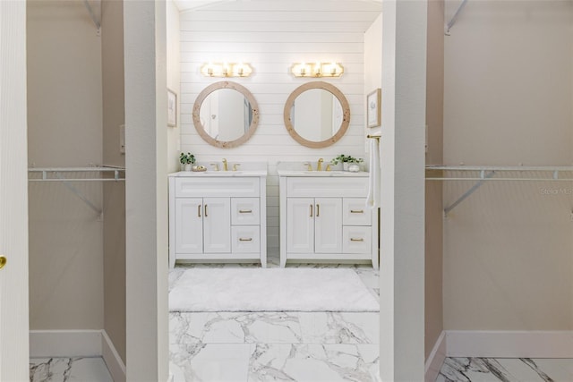 956 Harbor Town Dr, Venice, FL 34292 - bathroom featuring marble look tiles, vanity, a walk in closet, and baseboards