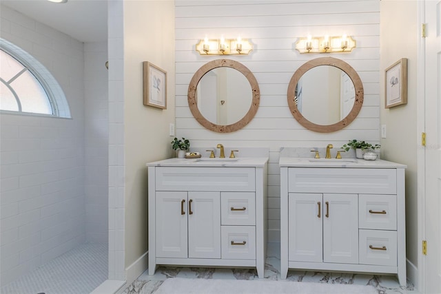 956 Harbor Town Dr, Venice, FL 34292 - full bathroom featuring marble look tiles, two vanities, and walk in shower