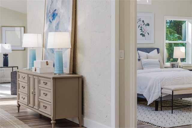 956 Harbor Town Dr, Venice, FL 34292 - bedroom featuring dark wood-style flooring and a textured wall