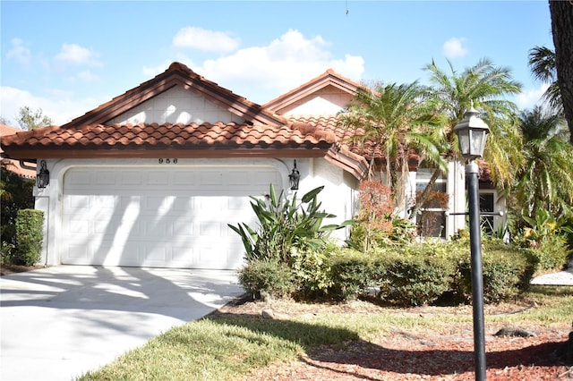 956 Harbor Town Dr, Venice, FL 34292 - mediterranean / spanish-style home with a tiled roof, an attached garage, driveway, and stucco siding