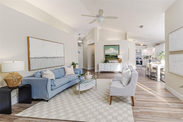 956 Harbor Town Dr, Venice, FL 34292 - living area with lofted ceiling, ceiling fan, light wood finished floors, and baseboards