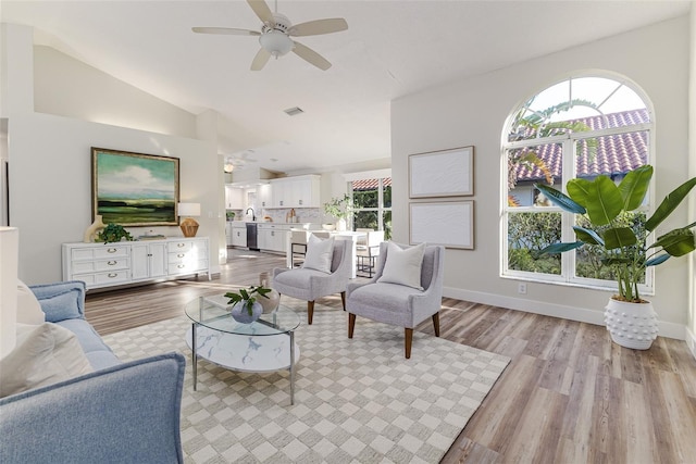 956 Harbor Town Dr, Venice, FL 34292 - living area with ceiling fan, light wood-style floors, vaulted ceiling, and baseboards