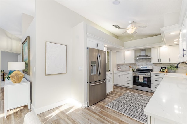 956 Harbor Town Dr, Venice, FL 34292 - kitchen with stainless steel appliances, wall chimney range hood, a sink, light countertops, and tasteful backsplash