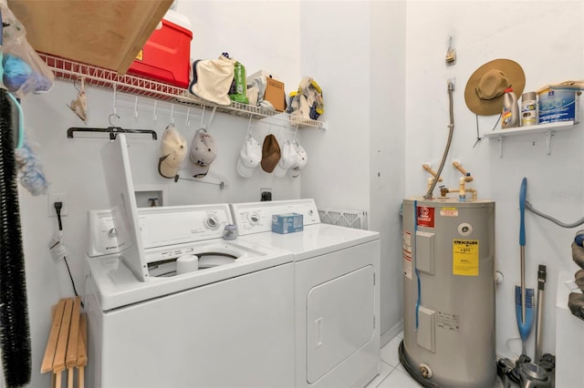 washroom with electric water heater, washing machine and dryer, and light tile patterned floors