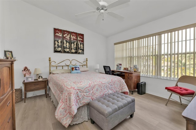 bedroom featuring vaulted ceiling, light wood-type flooring, and ceiling fan