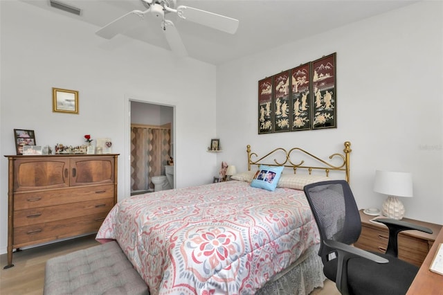 bedroom with ceiling fan, light hardwood / wood-style floors, and ensuite bath