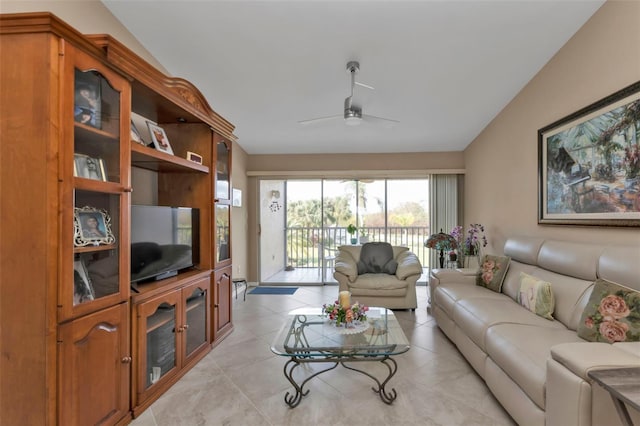 tiled living room featuring ceiling fan and lofted ceiling