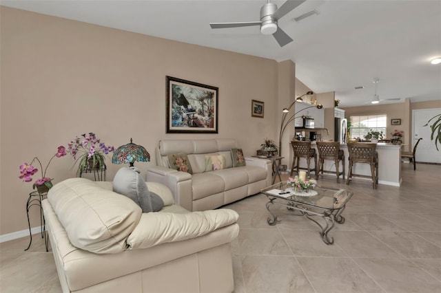 living room featuring light tile patterned floors and ceiling fan