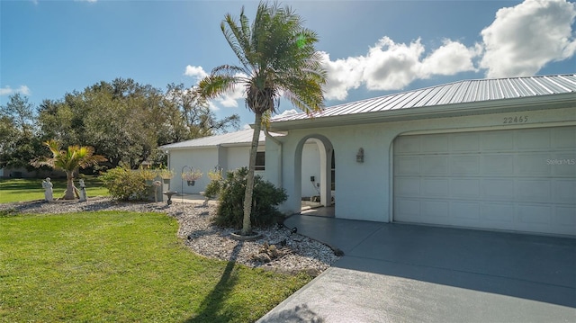 ranch-style house with a garage and a front lawn