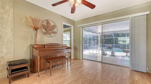 miscellaneous room with ceiling fan, a textured ceiling, and light hardwood / wood-style floors