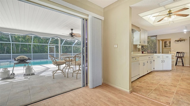 interior space featuring light wood-type flooring, ceiling fan, and sink