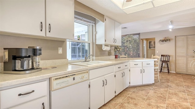 kitchen with white cabinetry, a textured ceiling, sink, and white dishwasher