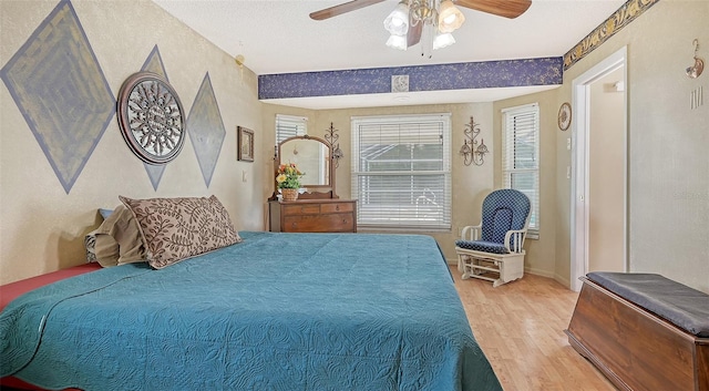 bedroom with wood-type flooring and ceiling fan