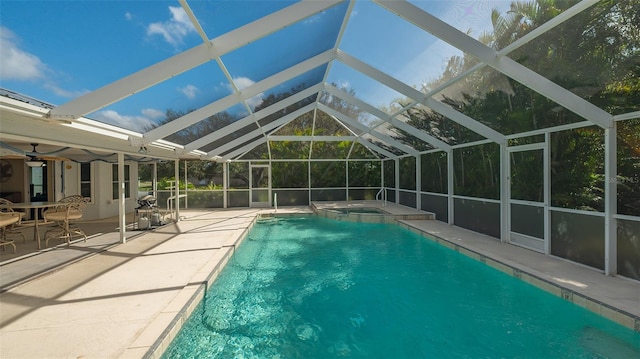 view of swimming pool with a patio, a lanai, and an in ground hot tub