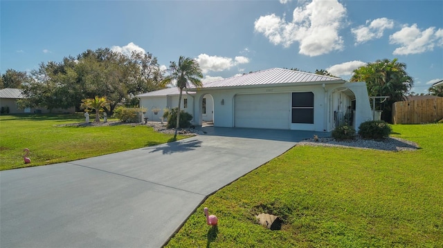 view of front of home with a front lawn and a garage