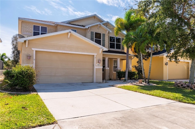 view of front of property featuring driveway, an attached garage, and stucco siding