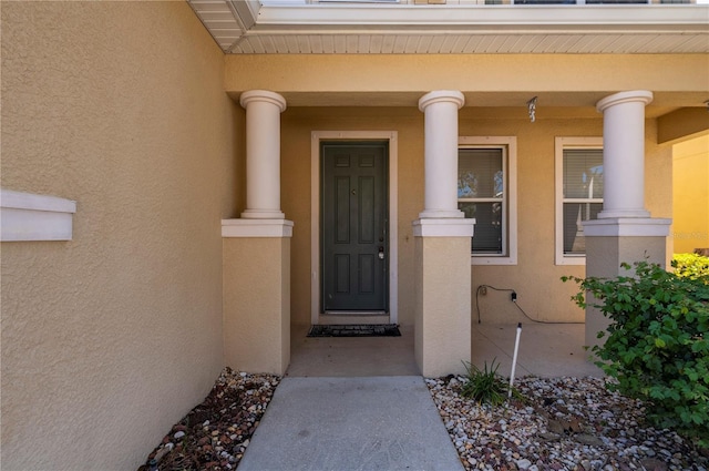 view of exterior entry featuring a porch