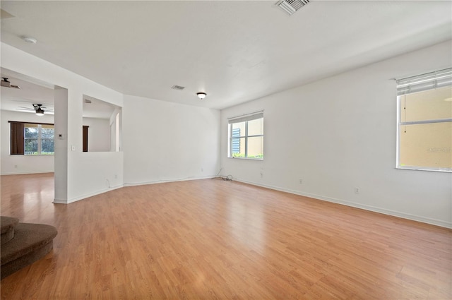 spare room with ceiling fan and light wood-type flooring