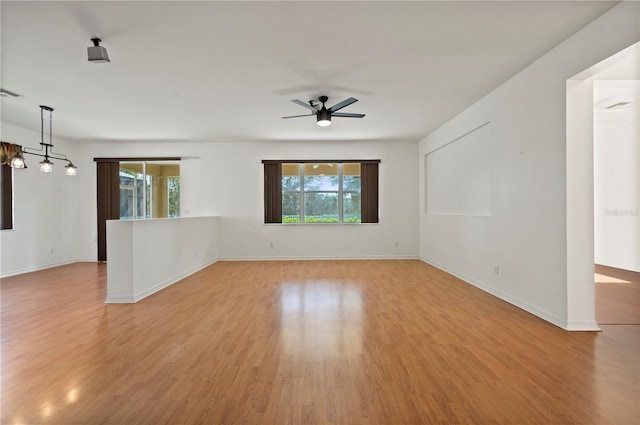 unfurnished room featuring light hardwood / wood-style floors, plenty of natural light, and ceiling fan