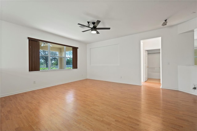 empty room featuring ceiling fan and light hardwood / wood-style floors