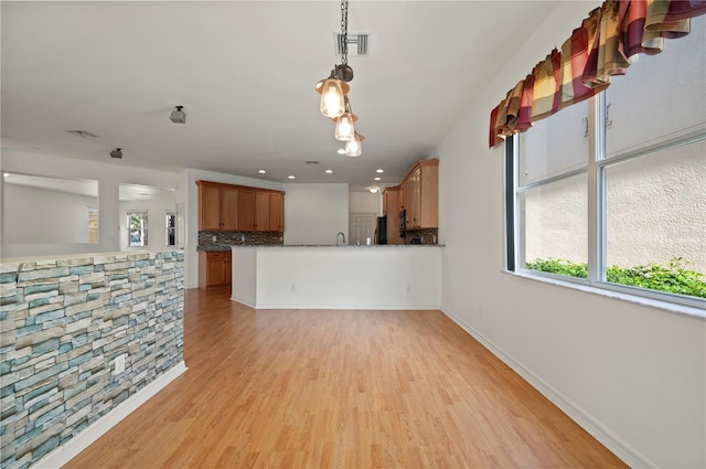 unfurnished living room with light wood-type flooring and sink