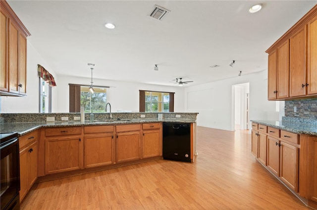 kitchen with dishwasher, backsplash, range with electric cooktop, sink, and light wood-type flooring