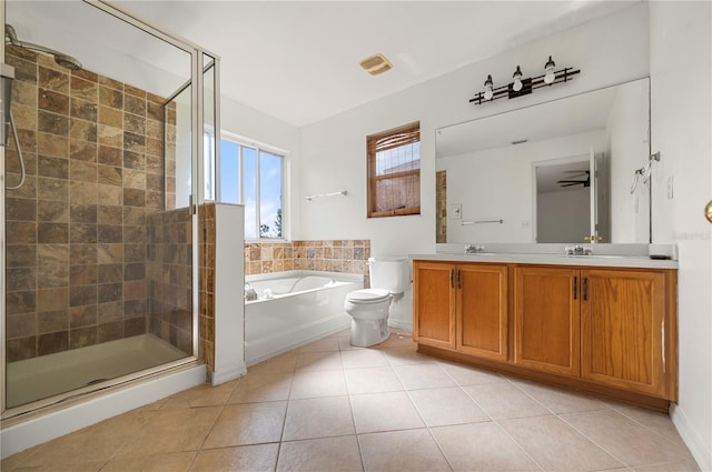 full bathroom featuring tile patterned floors, separate shower and tub, vanity, and toilet