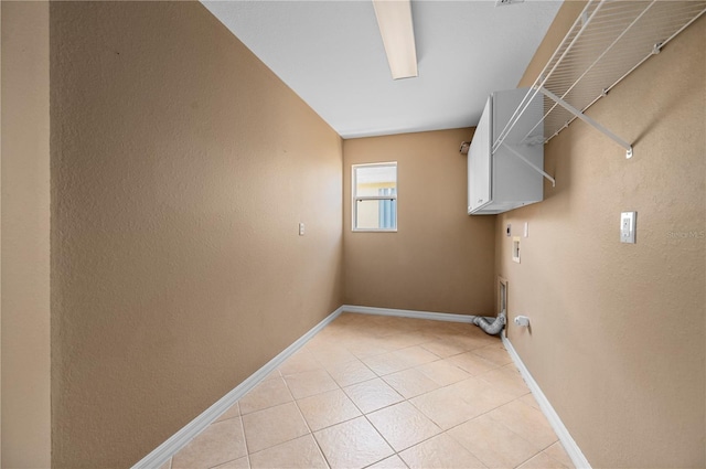 laundry area with hookup for an electric dryer, hookup for a washing machine, and light tile patterned flooring