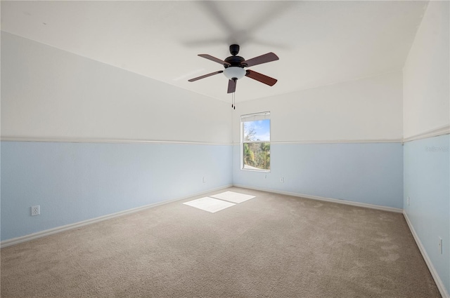 carpeted spare room with ceiling fan