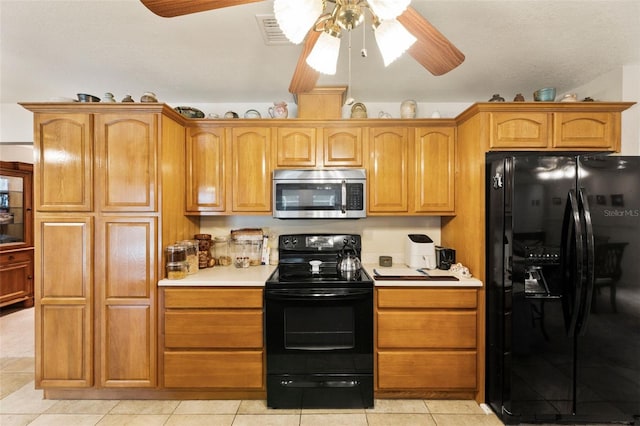 kitchen featuring ceiling fan, black appliances, and light tile patterned floors