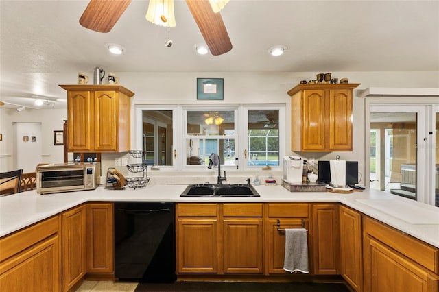 kitchen featuring ceiling fan, sink, and dishwasher