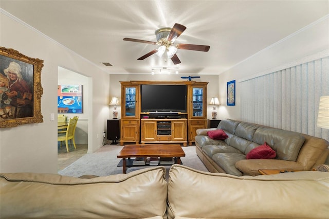 living room with ceiling fan and crown molding