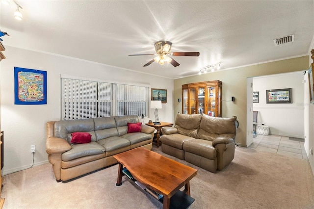 living room with crown molding, a textured ceiling, light colored carpet, and ceiling fan