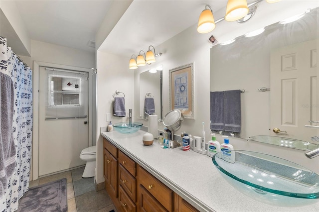 bathroom with vanity, toilet, and tile patterned floors