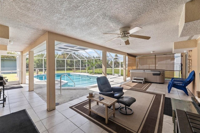 view of swimming pool with a hot tub, a patio, glass enclosure, and ceiling fan