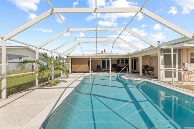 view of swimming pool with a patio area and a lanai