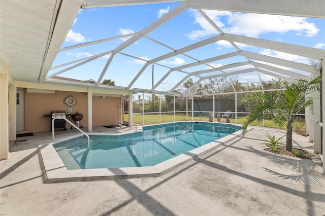 view of swimming pool with a patio, a lanai, a lawn, and area for grilling