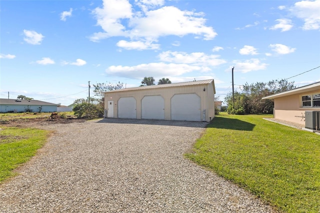 garage with central AC and a yard