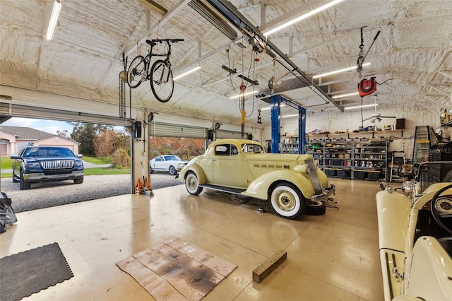 garage with a garage door opener and a workshop area