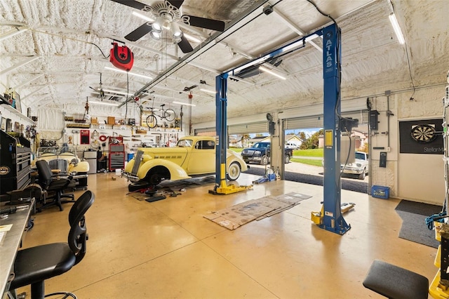 garage featuring ceiling fan and a workshop area