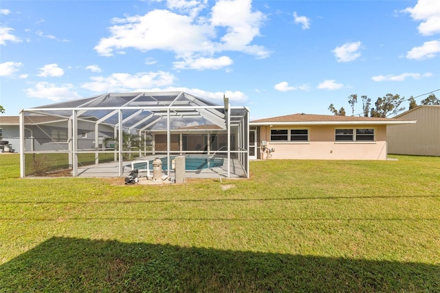 rear view of property featuring a patio area, a lanai, and a yard