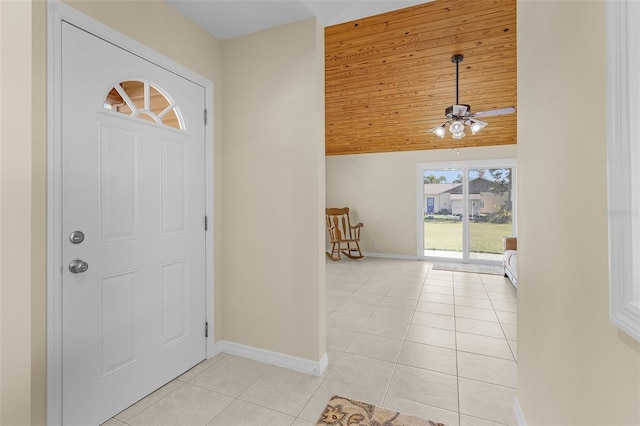 tiled foyer entrance with ceiling fan and wood ceiling