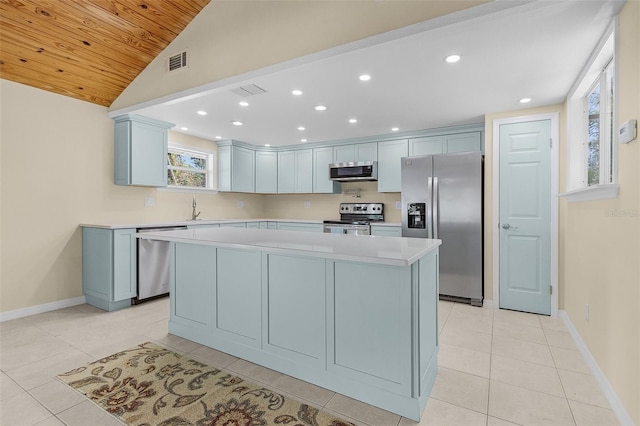 kitchen with sink, a center island, stainless steel appliances, and light tile patterned flooring