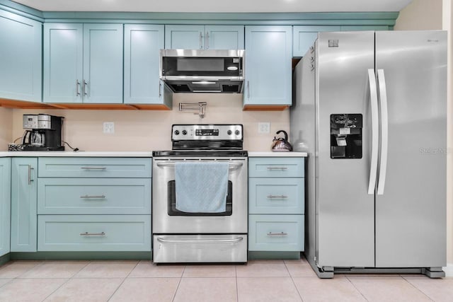 kitchen featuring light tile patterned floors and stainless steel appliances