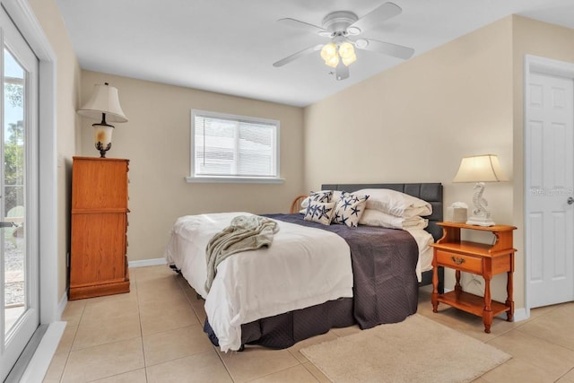 tiled bedroom featuring multiple windows and ceiling fan