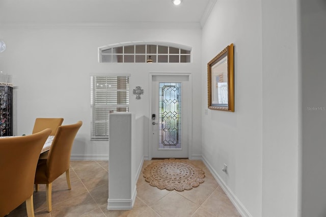 foyer entrance featuring crown molding and light tile patterned flooring