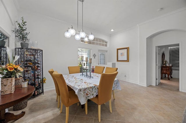 tiled dining space featuring crown molding